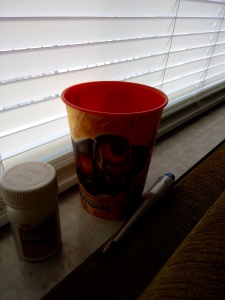 (Image is of a bottle of acetaminophen, an Iron Man cup, and a thermometer.}