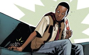 {Image is of Miles Morales, a twelve-year old African-American boy. He is sitting on a couch and holding a Popsicle in one hand. The other hand is being bitten by a large spider. Miles' eyes are wide with surprise.}